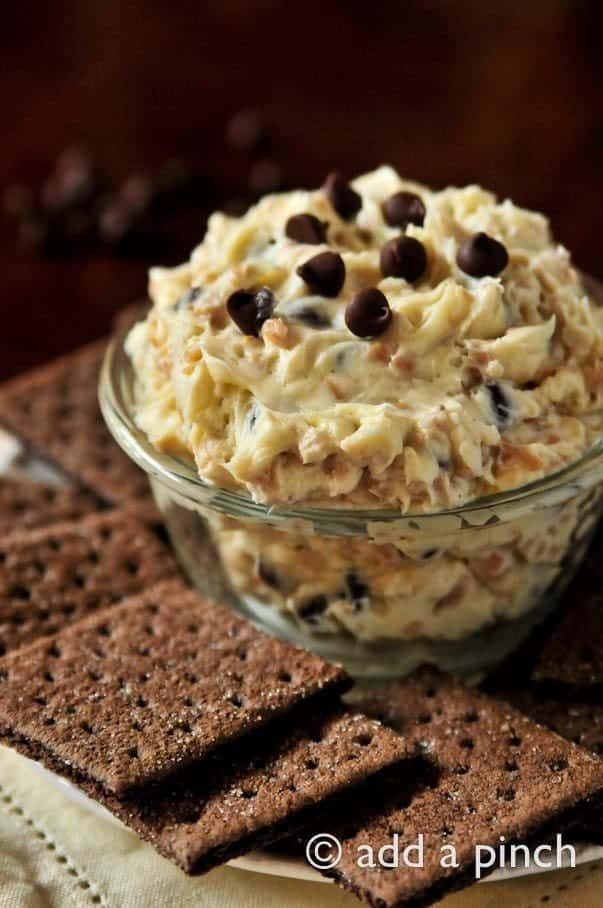 Cookie Dough Dip in glass bowl surrounded with chocolate graham crackers // addapinch.com