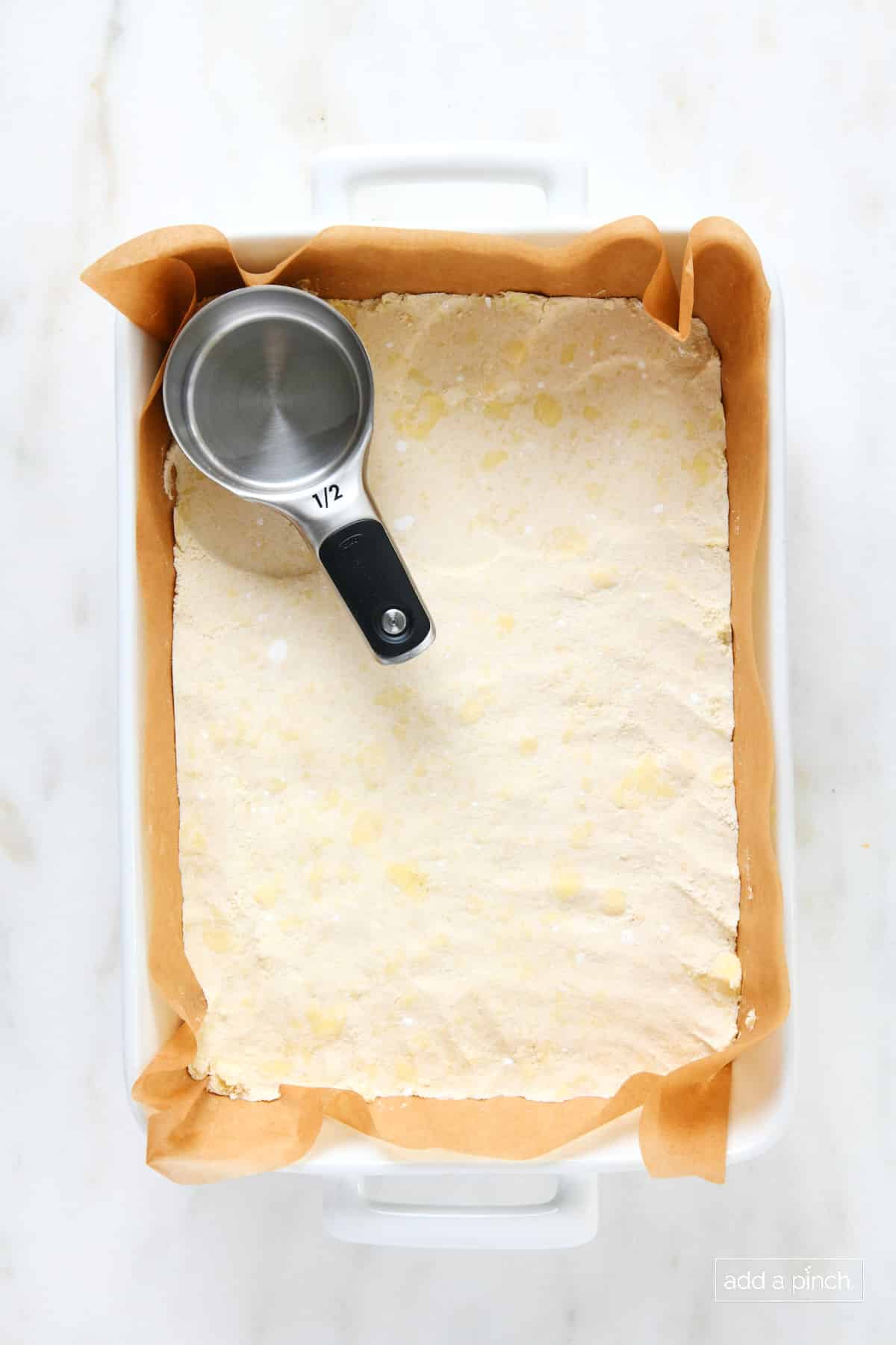 Press shortbread crust mixture into a parchment lined baking dish.