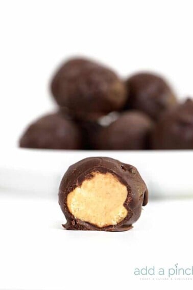 Peanut Butter Balls Recipe - the perfect combination of peanut butter and chocolate! This simple, no-bake recipe makes peanut butter balls everyone loves! // addapinch.com