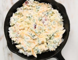 Jalapeno Popper Dip mixture in a skillet ready to be baked.