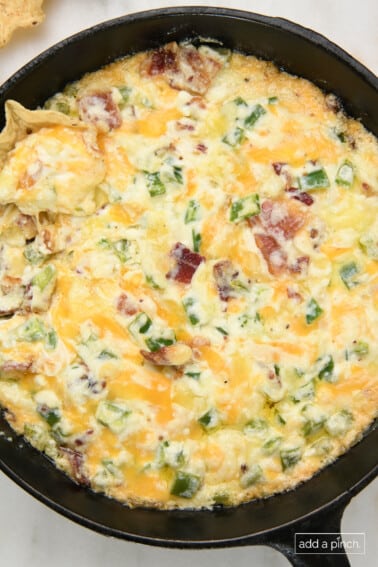 Jalapeno Popper Dip baked in a skillet with tortilla chips