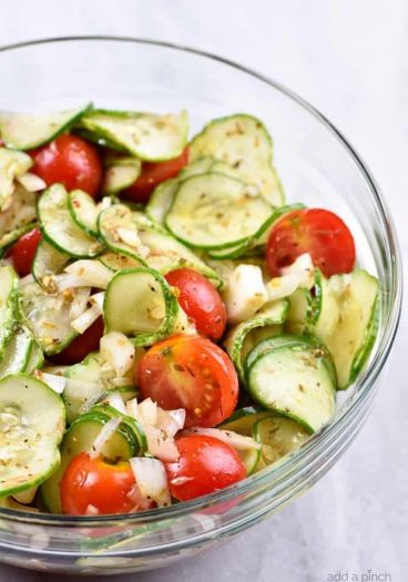 Cucumber Tomato Salad Recipe - A quick and easy summer staple, this cucumber and tomato salad goes well with fish, chicken, pork, or a plate filled with veggies! Add in onions too if you like! // addapinch.com