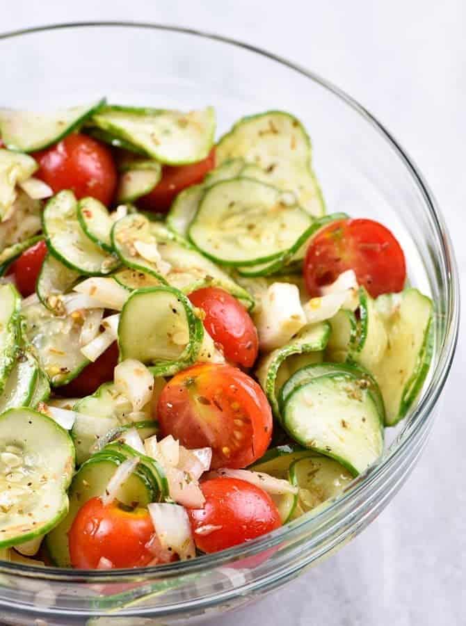 Cucumber Tomato Salad Recipe - A quick and easy summer staple, this cucumber and tomato salad goes well with fish, chicken, pork, or a plate filled with veggies! Add in onions too if you like! // addapinch.com