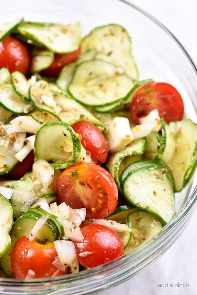 Cucumber Tomato Salad Recipe - A quick and easy summer staple, this cucumber and tomato salad goes well with fish, chicken, pork, or a plate filled with veggies! Add in onions too if you like! // addapinch.com