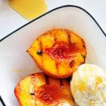 Grilled peaches with vanilla ice cream and honey is a perfect, simple and scrumptious summertime dessert. // addapinch.com