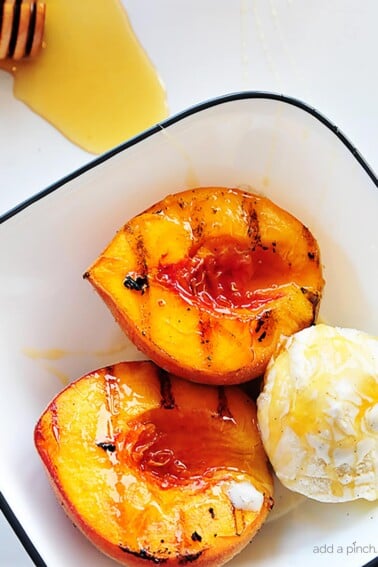 Grilled peaches with vanilla ice cream and honey is a perfect, simple and scrumptious summertime dessert. // addapinch.com