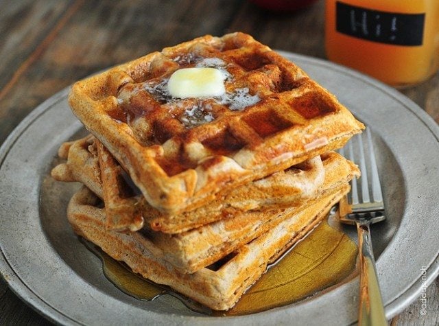 Apple Cider Waffles on a pewter plate with fork - addapinch.com
