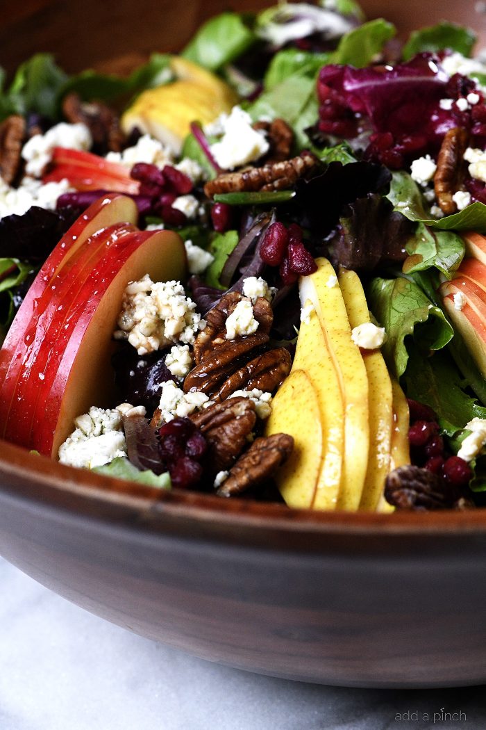 Apple Pear Salad with Pomegranate Vinaigrette and roasted pecans and blue cheese crumbles -addapinch.com