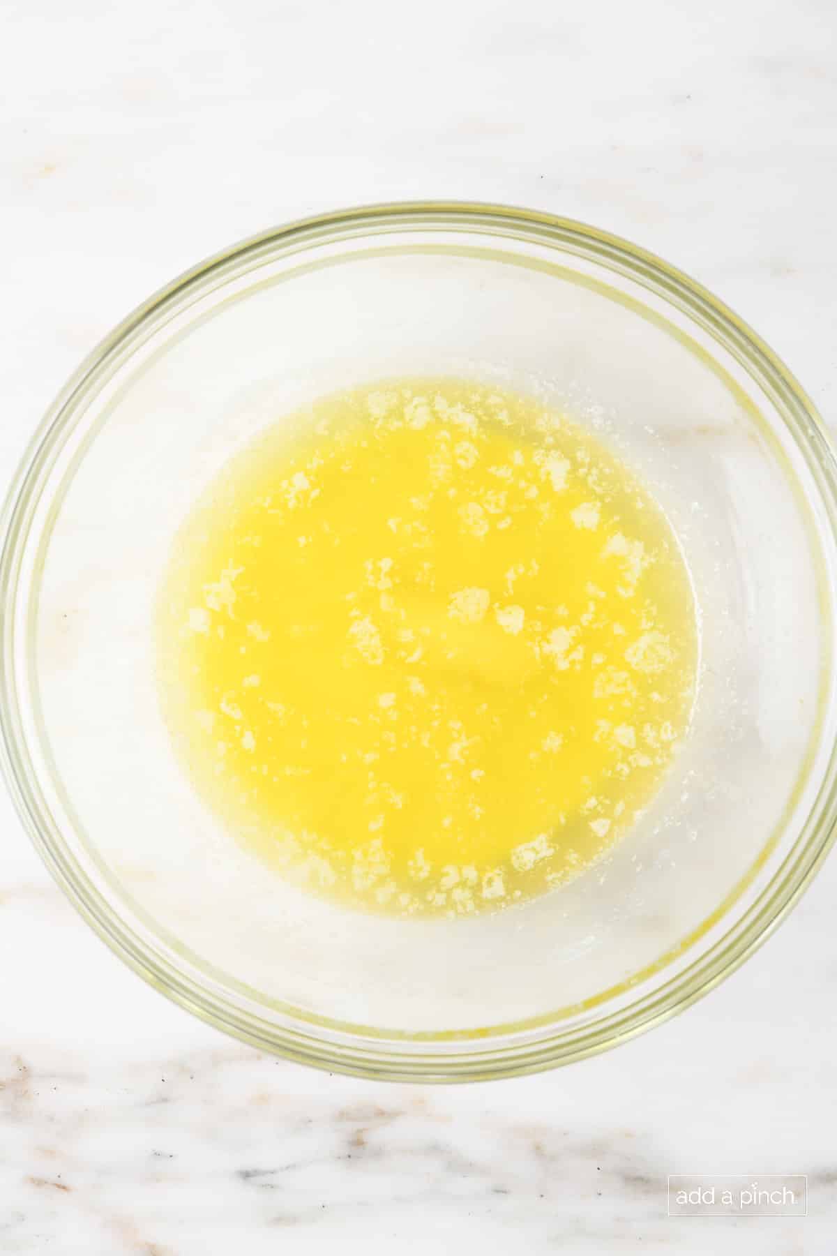 Melted butter in a glass bowl.