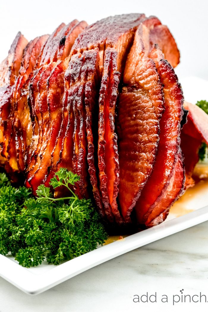 Cola Glazed Ham Recipe - This classic cola glazed hamÂ recipe with brown sugar makes an easy baked ham perfect for any occasion! Â // addapinch.com