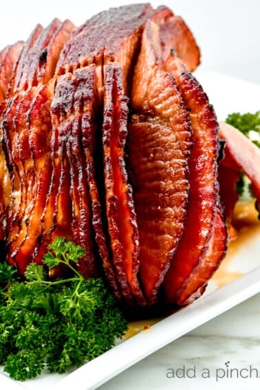 Cola Glazed Ham Recipe - This classic cola glazed ham recipe with brown sugar makes an easy baked ham perfect for any occasion!  // addapinch.com