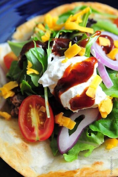 Taco Salad Recipe - Taco salad makes a delicious quick-fix supper or game day meal! This recipe comes together in minutes! // addapinch.com