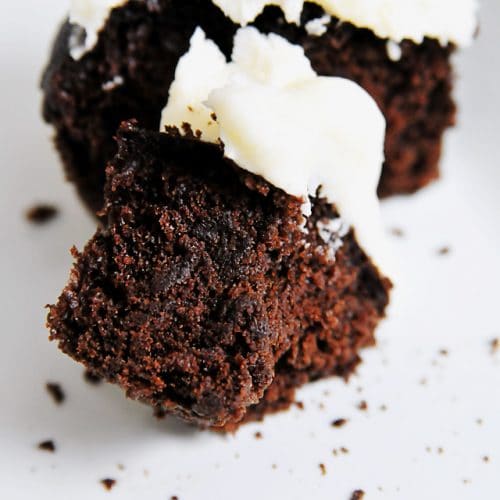Photograph of chocolate cupcakes with white frosting