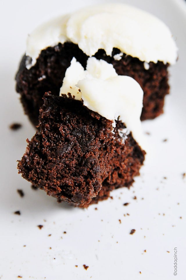 Photograph of chocolate cupcakes with white frosting