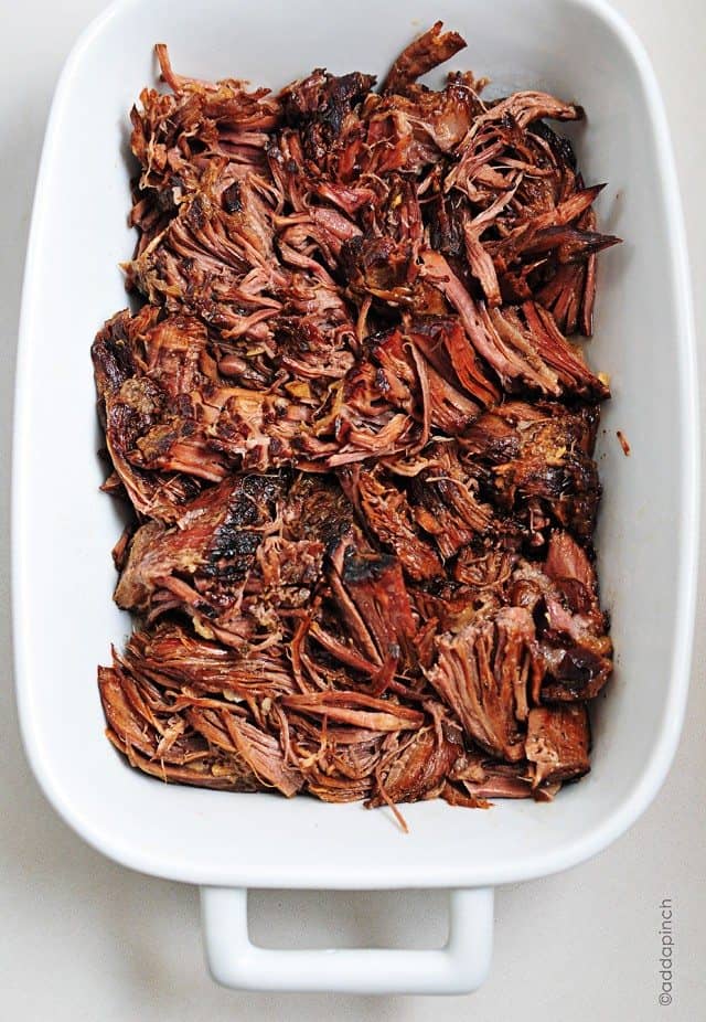 Slow cooker balsamic roast in a white baking dish.