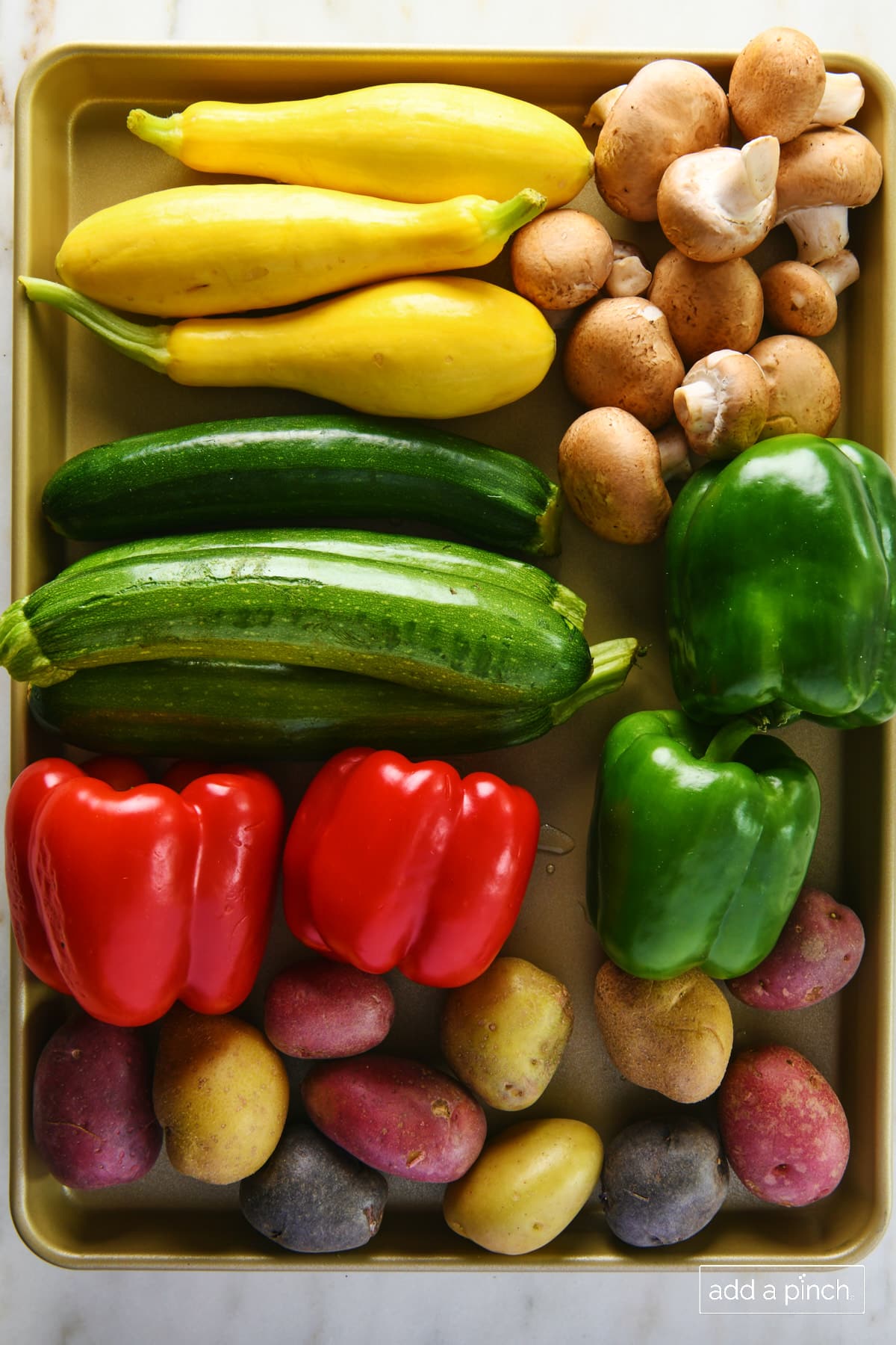 Photo of fresh vegetables on a baking sheet.