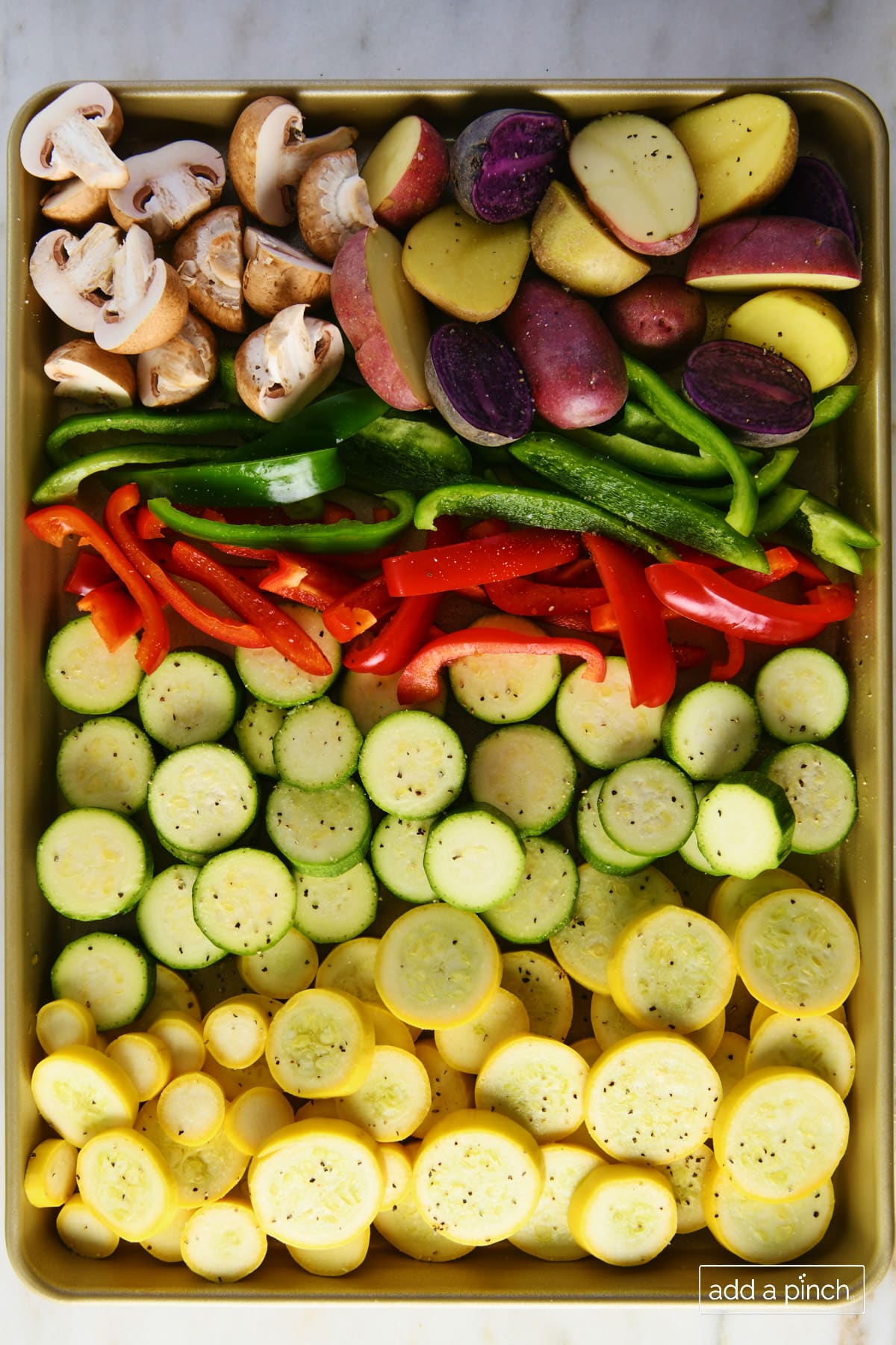 Vegetables on a baking sheet ready to be roasted.