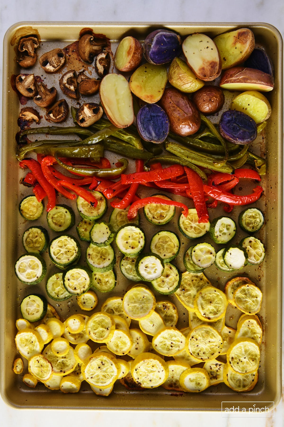 Roasted vegetables on a baking sheet.
