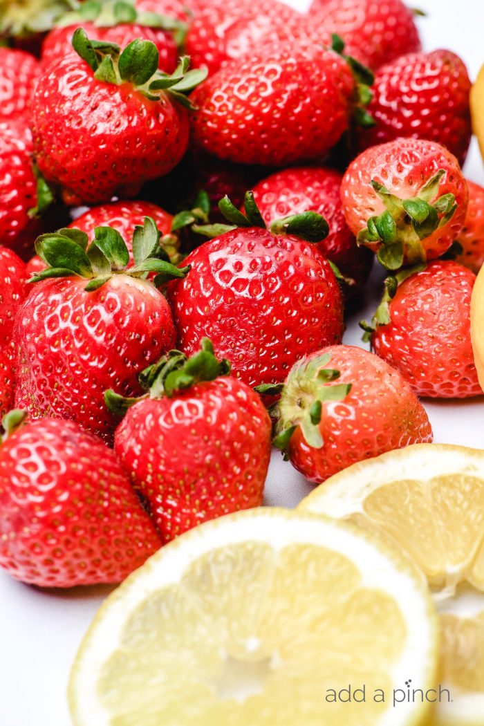 Fresh strawberries and fresh lemon slices // addapinch.com