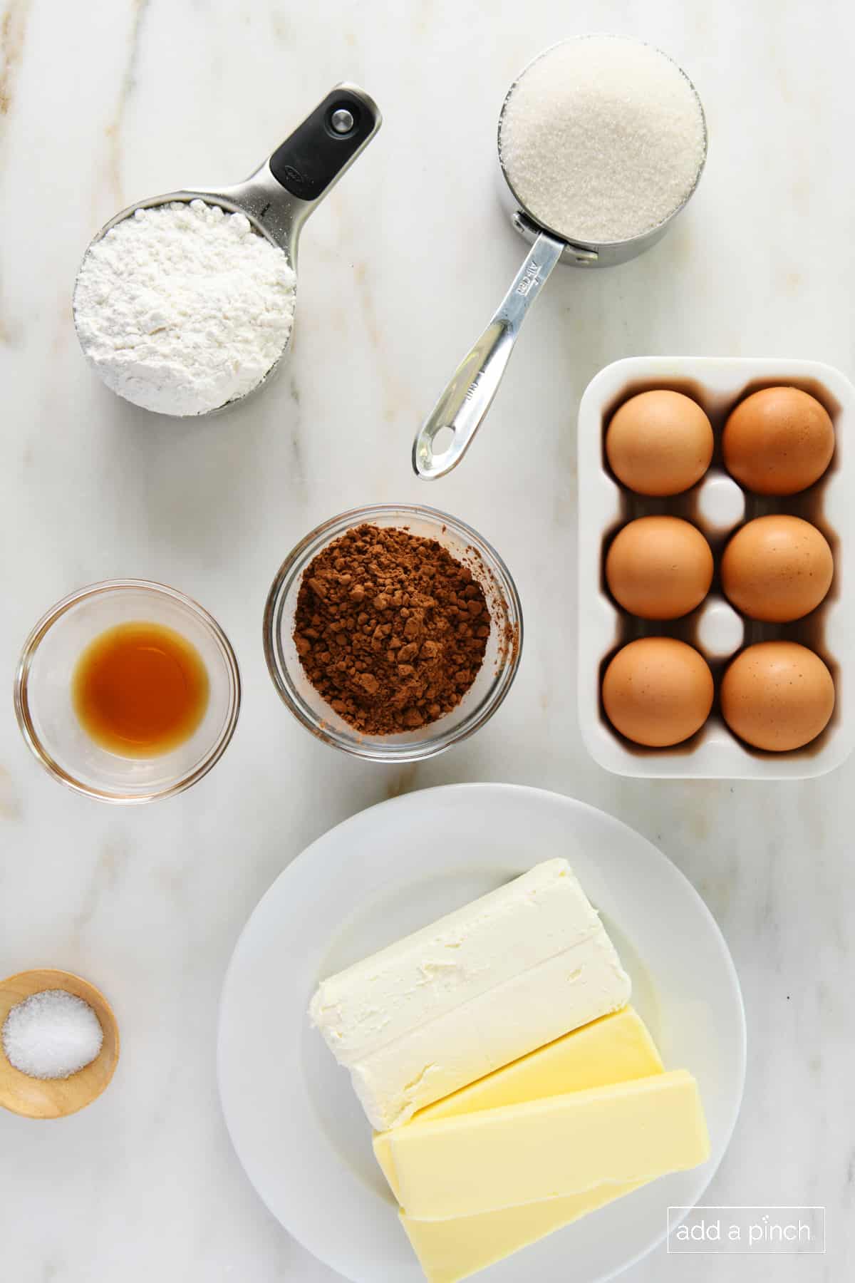 Photo of ingredients used to make chocolate pound cake on a marble surface.