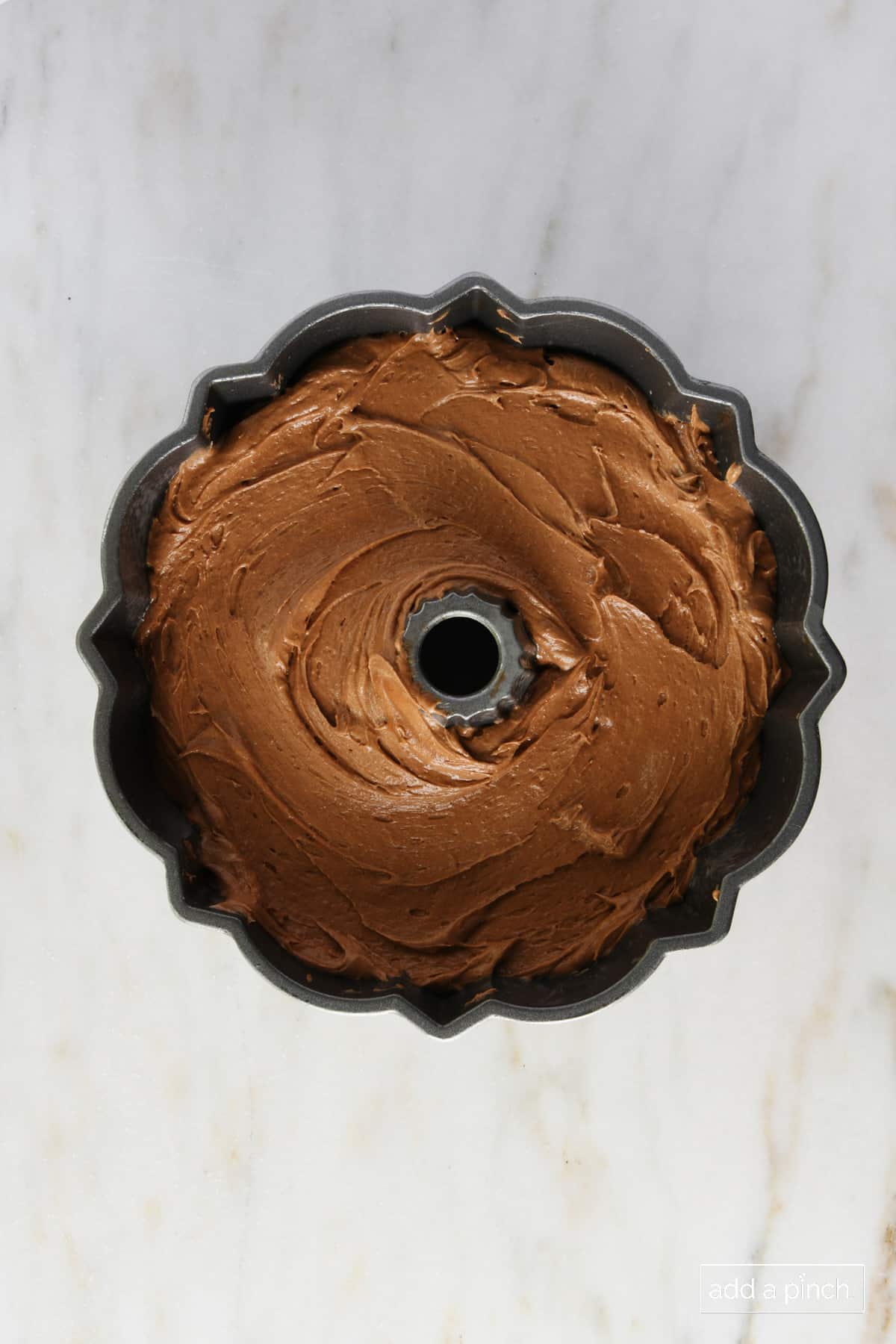 Chocolate pound cake batter in a bundt pan ready to bake.