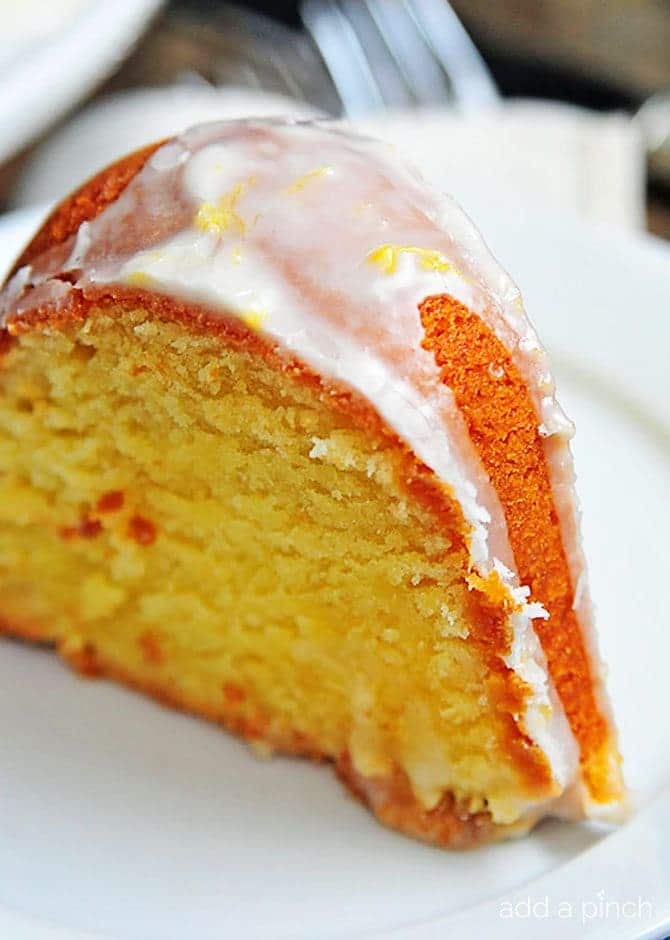 Lemon Pound Cake slice with glaze on top. // addapinch.com