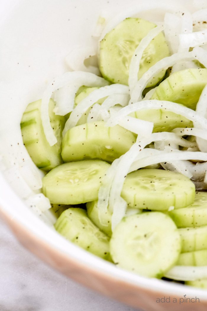 CucumberÂ Salad Recipe - This refreshing cucumber salad is a great side dish for any meal - chicken, beef, pork, fish, or vegetables! A longtime family favorite ready in minutes and full of flavor! // addapinch.com