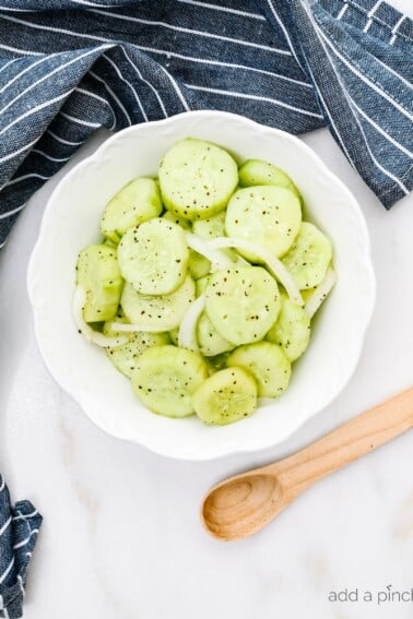 Cucumber Salad Recipe - This refreshing cucumber salad is a great side dish for any meal - chicken, beef, pork, fish, or vegetables! A longtime family favorite ready in minutes and full of flavor! // addapinch.com