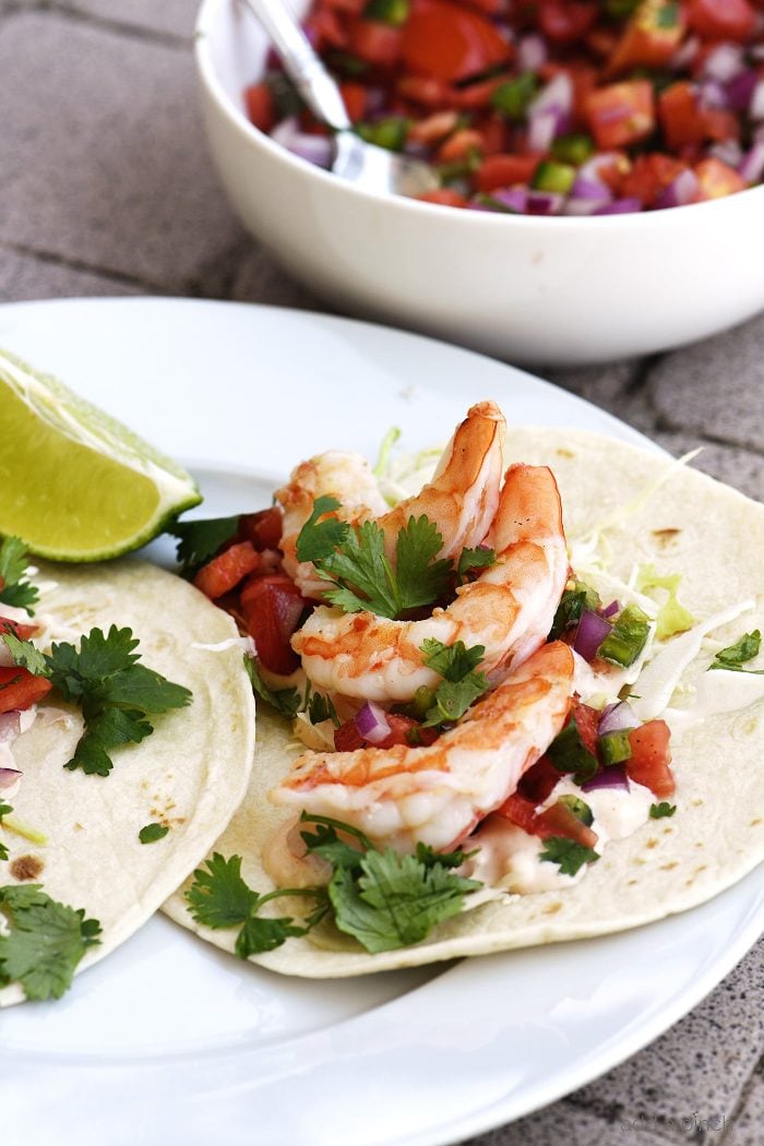 Shrimp Tacos Recipe - These quick and easy shrimp tacos are always a favorite. Made with delicious, tender grilled shrimp for a spicy, perfect shrimp taco! // addapinch.com