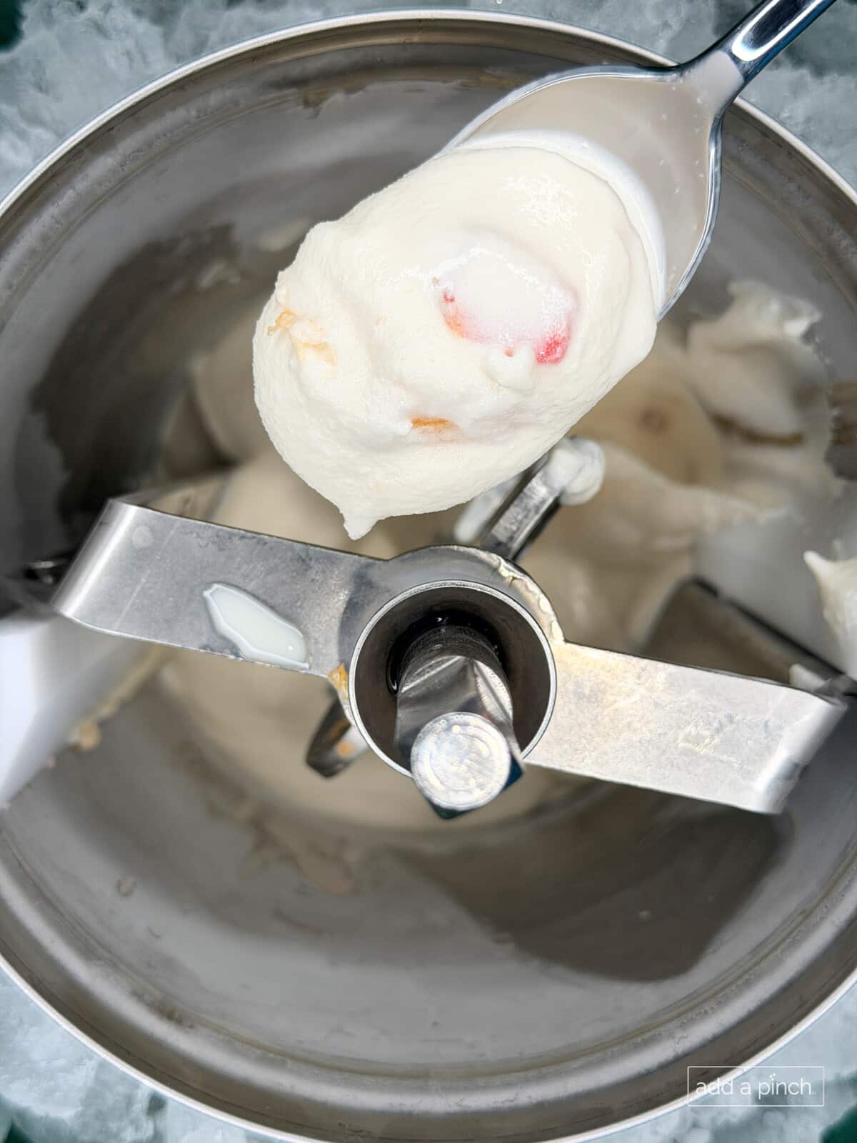 Homemade peach ice cream churned in ice cream maker and ready to be served soft serve or frozen for a scoopable ice cream.
