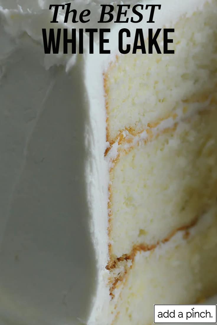 Close up of sliced white cake with white frosting - with text - addapinch.com