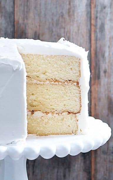 Close photo of layers of white cake with white frosting.
