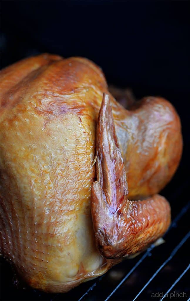 Smoked Turkey Recipe - This simple, yet scrumptious smoked turkey brings the juiciest and most flavorful turkey to your Thanksgiving table. // addapinch.com