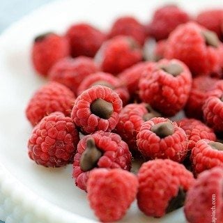 Chocolate Filled Raspberries on a white plate.