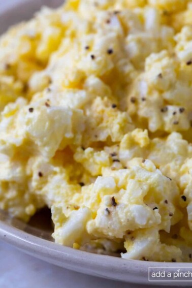 Close photograph of egg salad in a serving bowl.