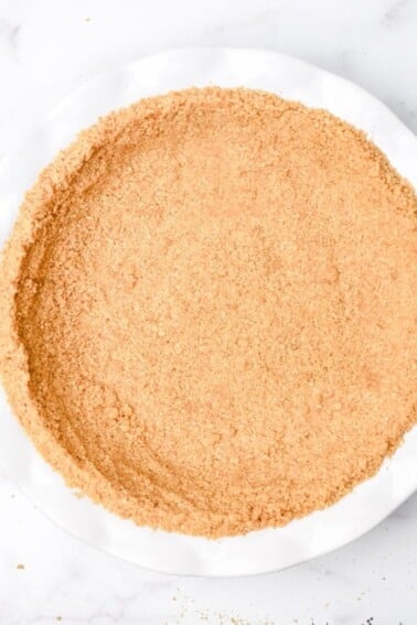 A simple graham cracker crust is perfect for so many recipes. From key lime pie to a chocolate tart, a graham cracker crust is a never fail favorite. // addapinch.com