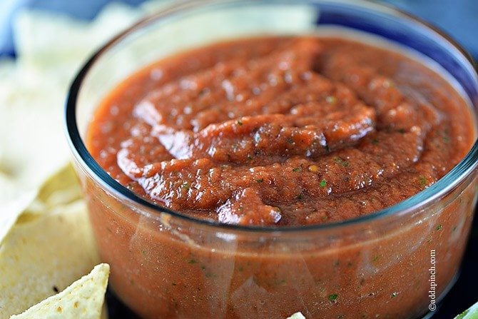 Best Homemade Salsa in a glass jar surrounded with tortilla chips // addapinch.com