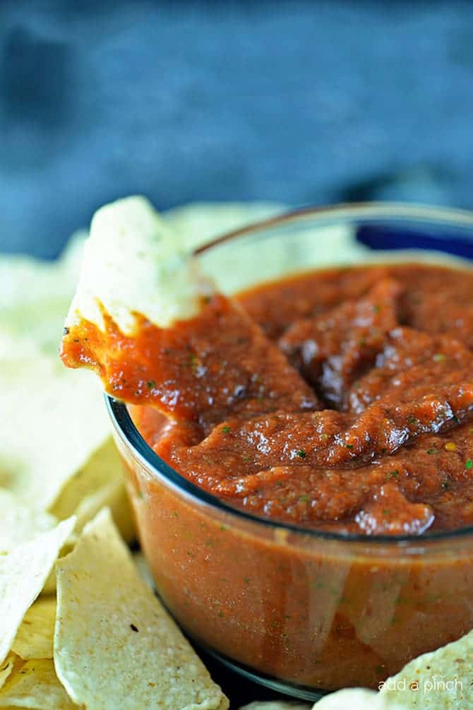 Best Homemade Salsa Recipe in a glass bowl surrounded with tortilla chips - addapinch.com