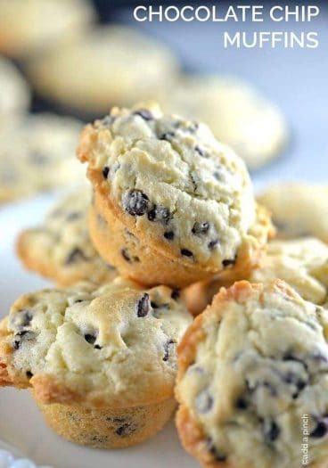 Photograph of stack of chocolate chip muffins on a white plate. // addapinch.com