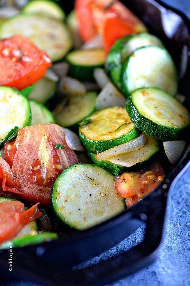Zucchini and tomatoes in a cast iron skillet // addapinch.com