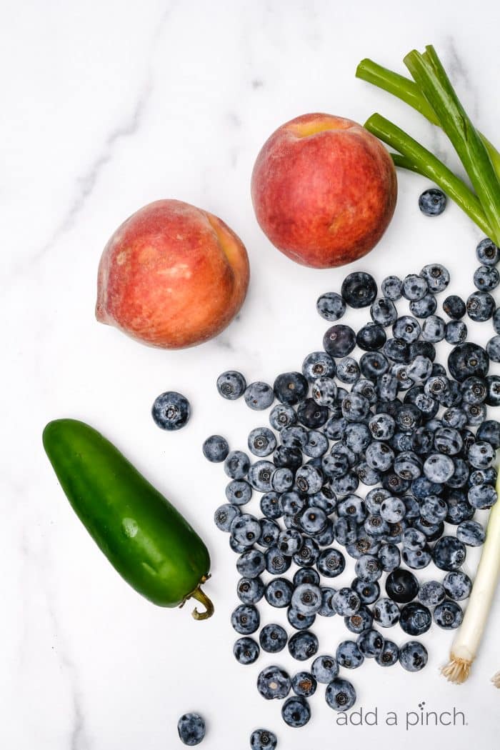 Blueberry Peach Salsa makes a delicious fruit salsa. Made of blueberries, peaches and a few other simple ingredients, this blueberry peach salsa is a summertime favorite. // addapinch.com