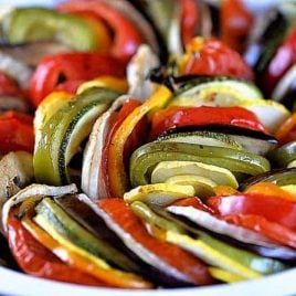 White pie plate filled with various fresh, colorful vegetables. // addapinch.com