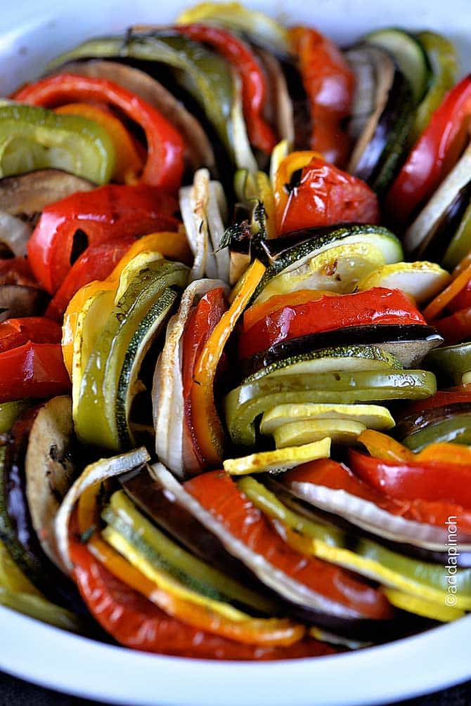 White pie plate filled with ratatouille made with a variety of colorful vegetables. // addapinch.com