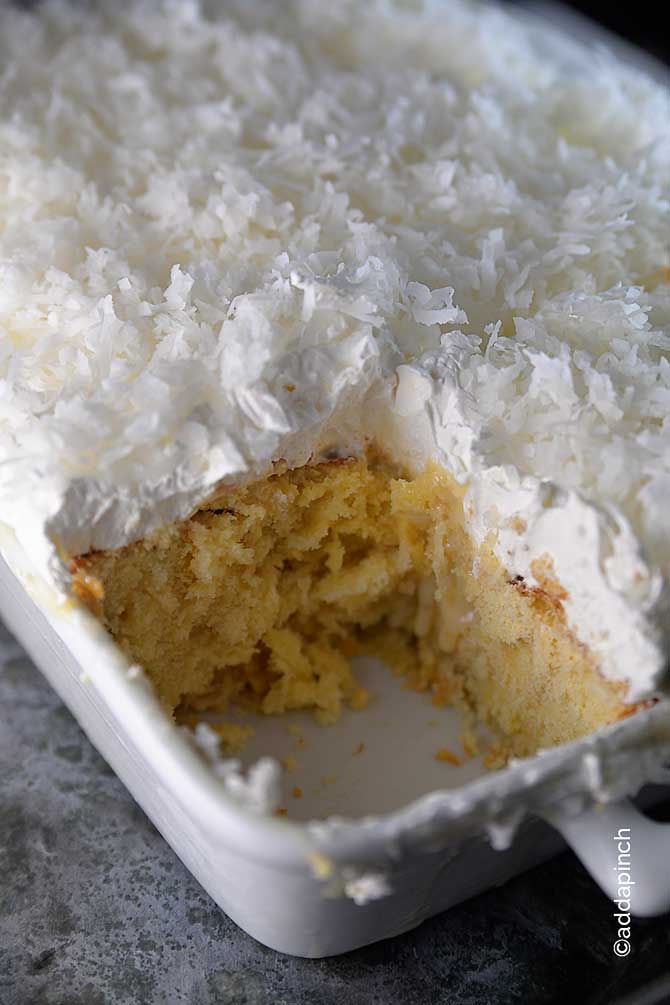 Photo of coconut cake in white dish.
