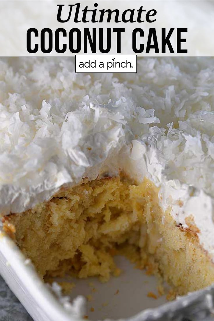 Coconut Cake in baking dish with slice removed - with text - addapinch.com