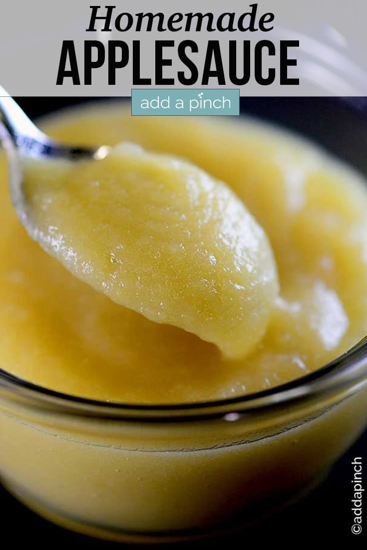 Bowl of smooth homemade applesauce, with some dipped in spoon - with text - addapinch.com