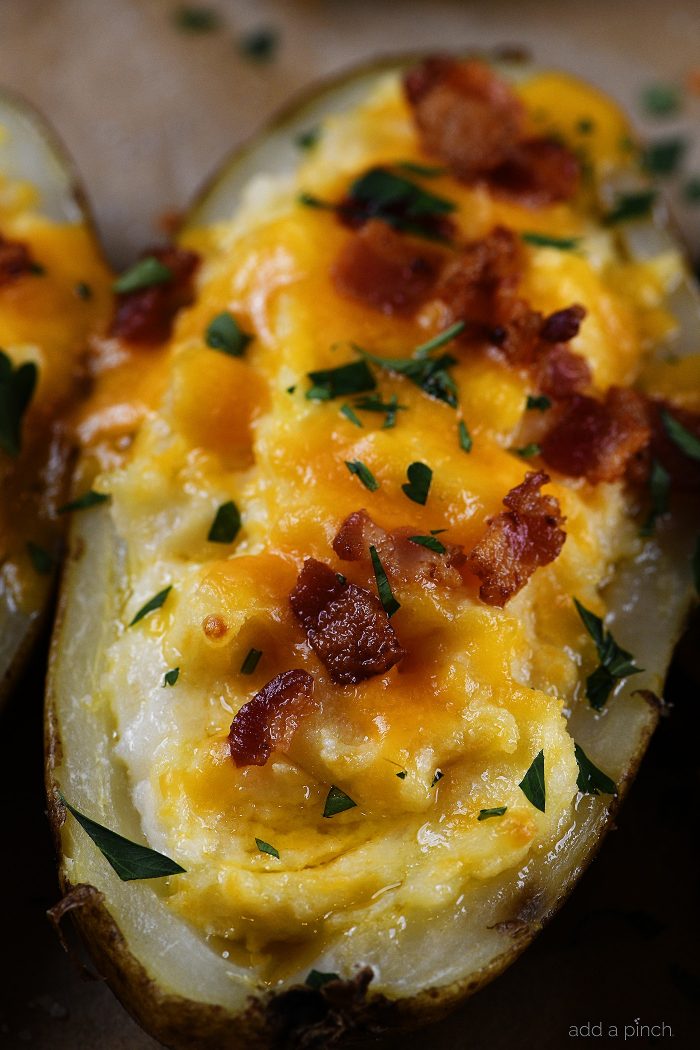 Twice Baked Potatoes Recipe - These potatoes make any meal an event! They take baked potatoes to a whole new level of creamy, cheesy, buttery deliciousness. Easy enough to make ahead in stages, twice baked potatoes make an elegant side dish when entertaining! // addapinch.com