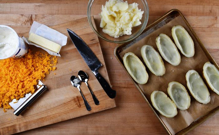 Twice Baked Potatoes Recipe - These potatoes make any meal an event! They take baked potatoes to a whole new level of creamy, cheesy, buttery deliciousness. Easy enough to make ahead in stages, twice baked potatoes make an elegant side dish when entertaining! // addapinch.com