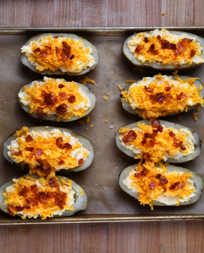 Twice Baked Potatoes Recipe - These potatoes make any meal an event! They take baked potatoes to a whole new level of creamy, cheesy, buttery deliciousness. Easy enough to make ahead in stages, twice baked potatoes make an elegant side dish when entertaining! // addapinch.com
