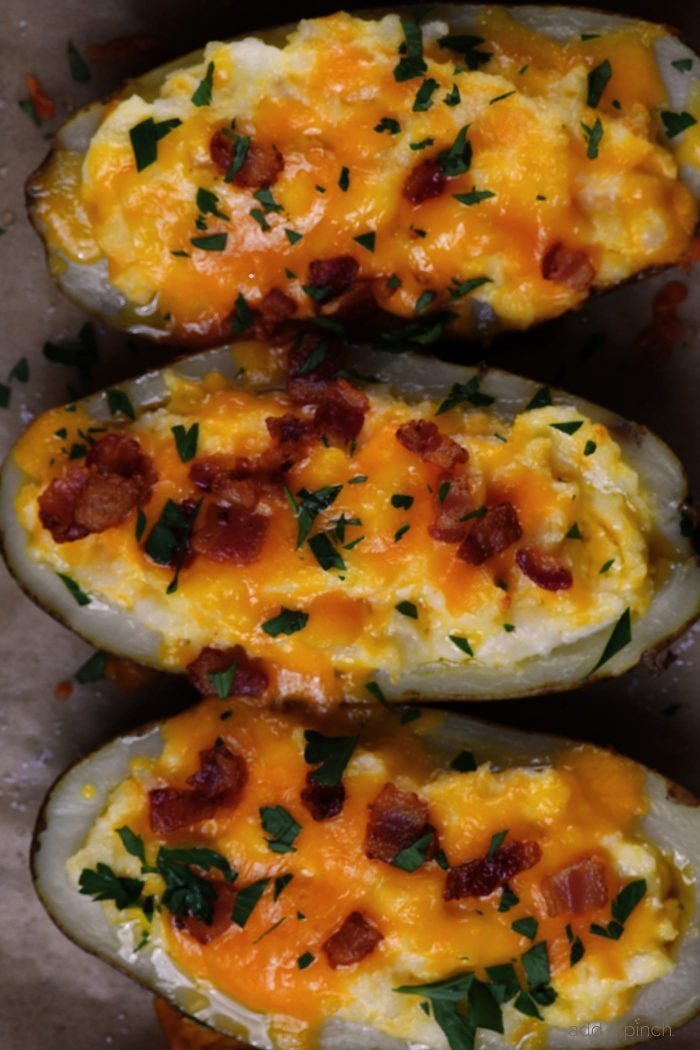 Twice Baked Potatoes Recipe - These potatoes make any meal an event! They take baked potatoes to a whole new level of creamy, cheesy, buttery deliciousness. Easy enough to make ahead in stages, twice baked potatoes make an elegant side dish when entertaining! // addapinch.com